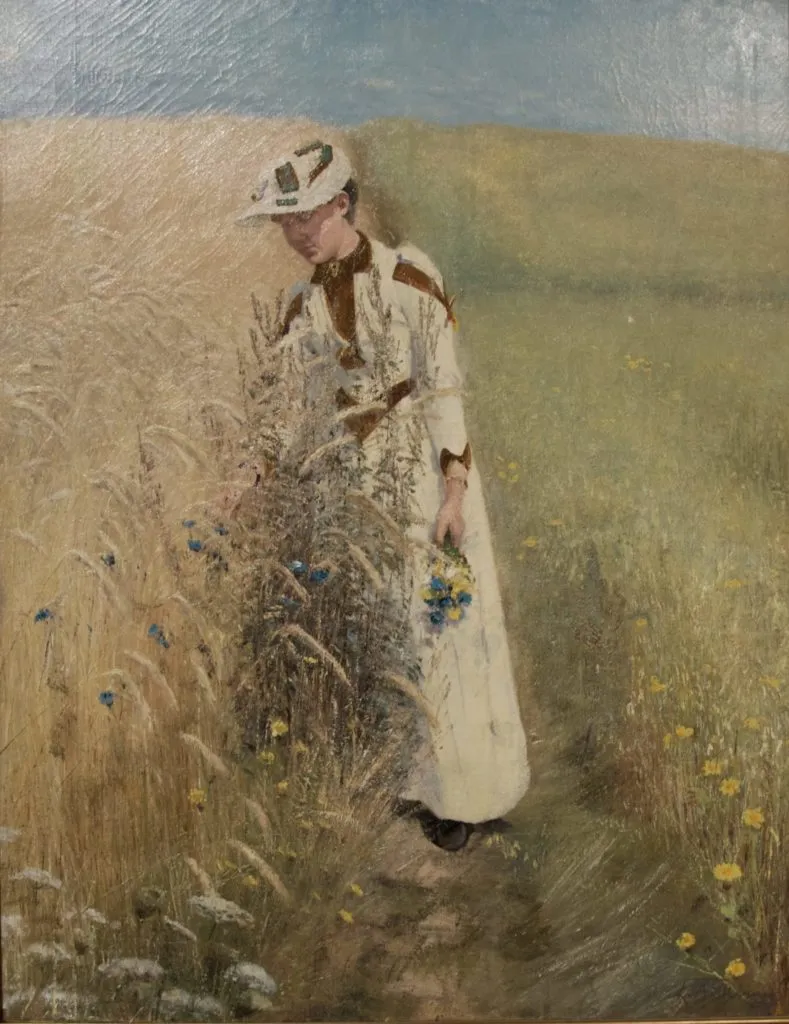 Dipinto di Ring: donna in bianco coglie fiordalisi in un campo di grano