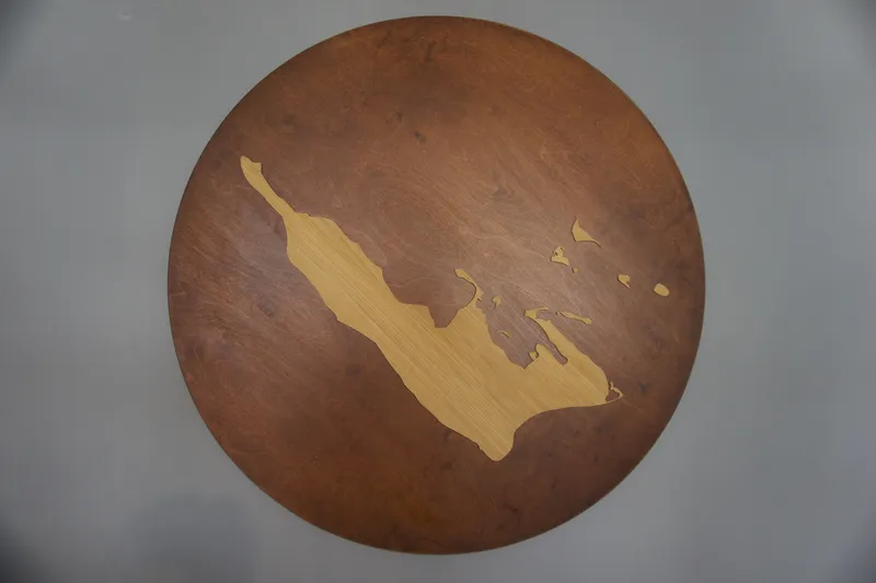 Tavolo rotondo in legno con la sagoma intarsiata dell'isola di Ærø