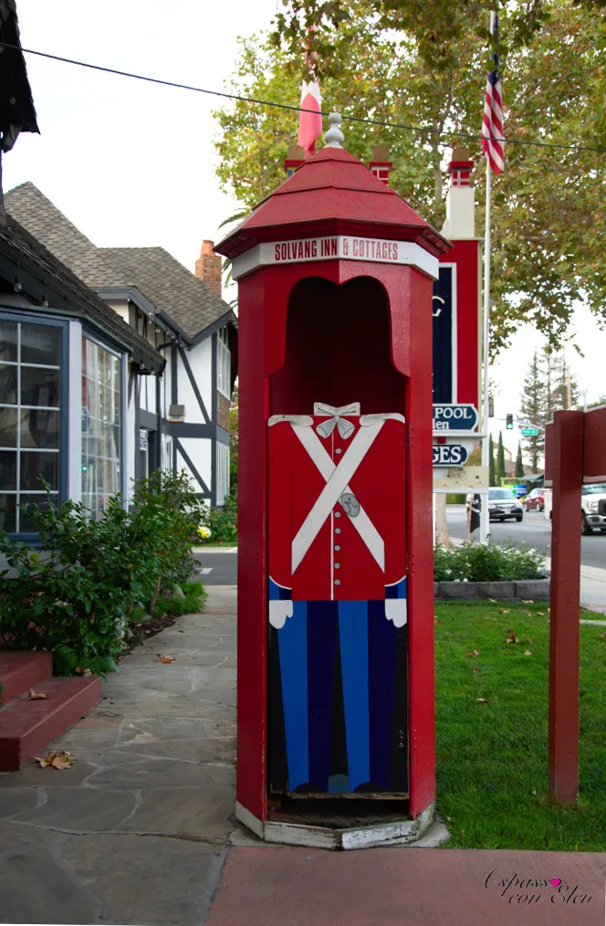 Red kiosk painted with a toy soldier on a Solvang sidewalk