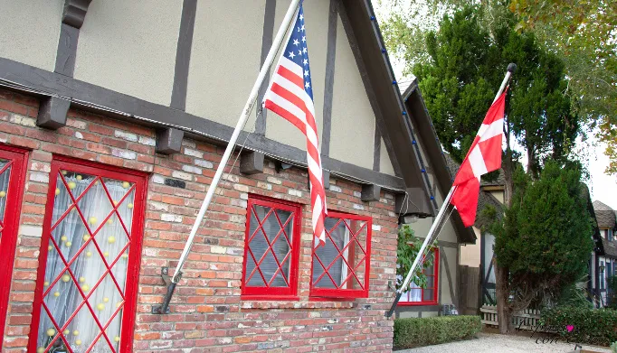Half-timbered house flying American and Danish flags in Solvang