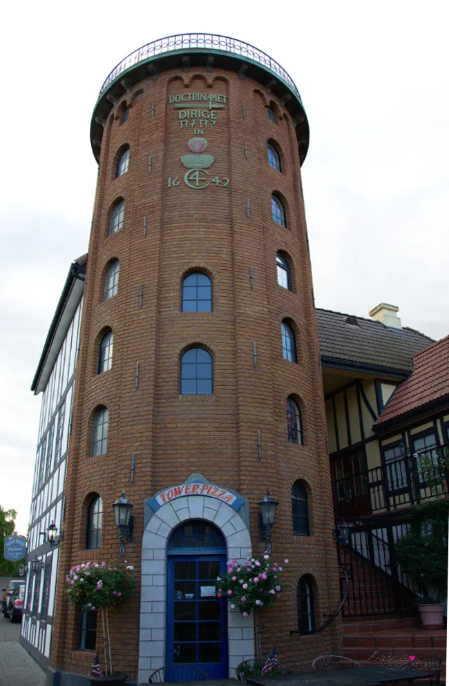 Round Tower replica in brick with a Tower Pizza sign in Solvang