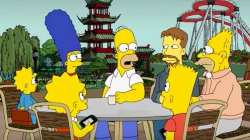 I Simpson seduti a un tavolo in un parco divertimenti