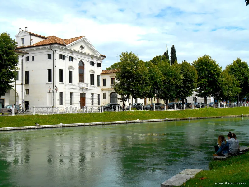 Riviera Santa Margherita in Treviso, historic white palace along a green canal