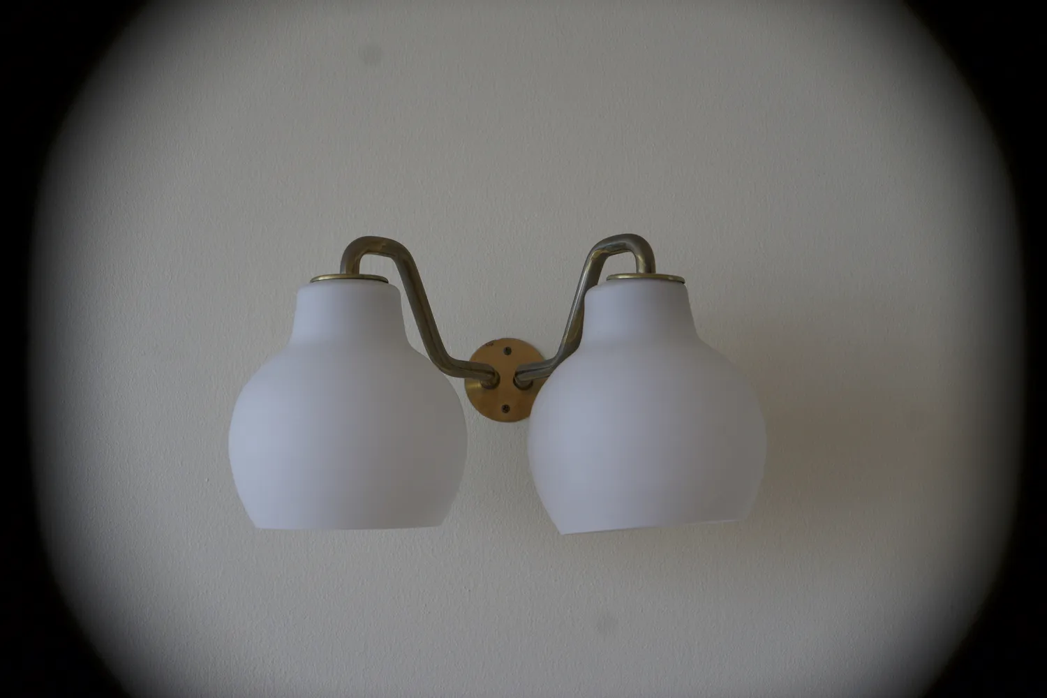 Applique da parete a due luci con paralumi bianchi e braccio in ottone